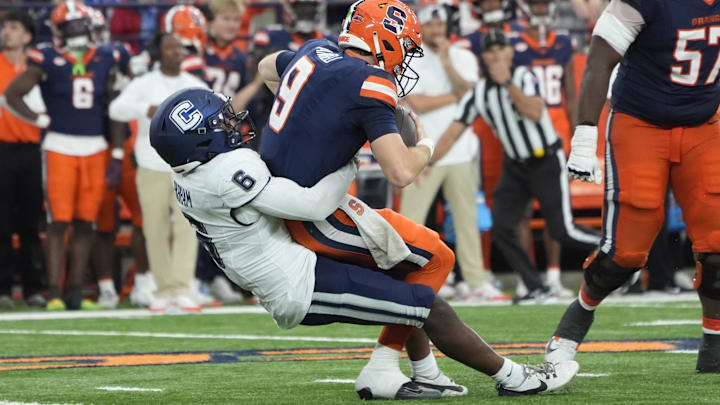 Former UW linebacker Bryun Parham sacks Syracuse's Steve Angeli for UConn.
