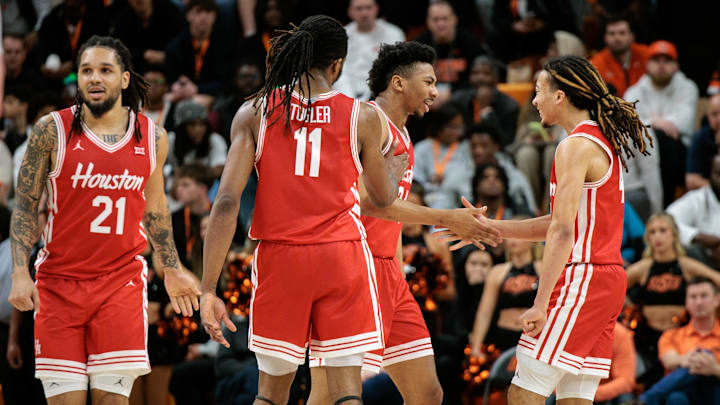 Mar 7, 2026; Stillwater, Oklahoma, USA; Houston Cougars guard Emanuel Sharp (21) and Houston Cougars guard Kingston Flemings (4) react after a play during the second half against the Oklahoma State Cowboys at Gallagher-Iba Arena. 