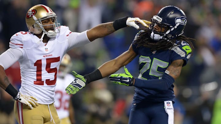Jan 19, 2014; Seattle, WA, USA; Seattle Seahawks cornerback Richard Sherman (25) gets shoved in the face by San Francisco 49ers wide receiver Michael Crabtree (15) while trying to shake hands after an interception by Seahawks outside linebacker Malcolm Smith (not pictured) during the second half of the 2013 NFC Championship football game at CenturyLink Field. Mandatory Credit: Kirby Lee-Imagn Images
