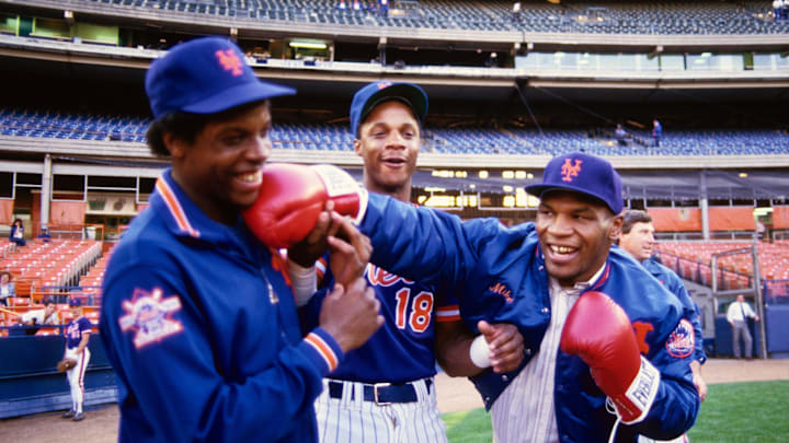 1990; Flushing, NY, USA; FILE PHOTO; New York Mets pitcher Dwight Gooden and right fielder Darryl Strawberry (18) joke around on the field with boxer Mike Tyson before a game at Shea Stadium. Mandatory Credit: Tony Tomsic-USA TODAY NETWORK