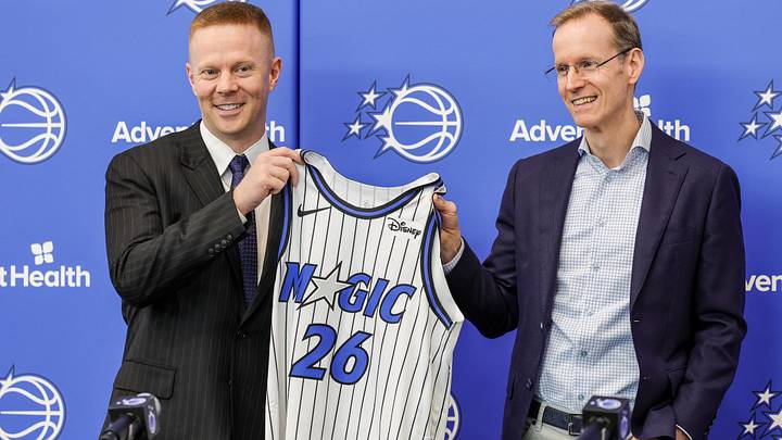 Jun 18, 2026; Orlando, FL, USA; Orlando Magic President of Basketball Operations Jeff Weltman (right) presents new head coach Sean Sweeney with a number 26 jersey before a press conference at AdventHealth Training Center. Mandatory Credit: Mike Watters-Imagn Images