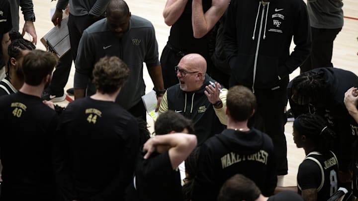 Feb 5, 2025; Stanford, California, USA; Wake Forest Demon Deacons head coach Steve Forbes (center) gestures as he talks to his players during a timeout in the second half against the Stanford Cardinal at Maples Pavilion. Mandatory Credit: D. Ross Cameron-Imagn Images
