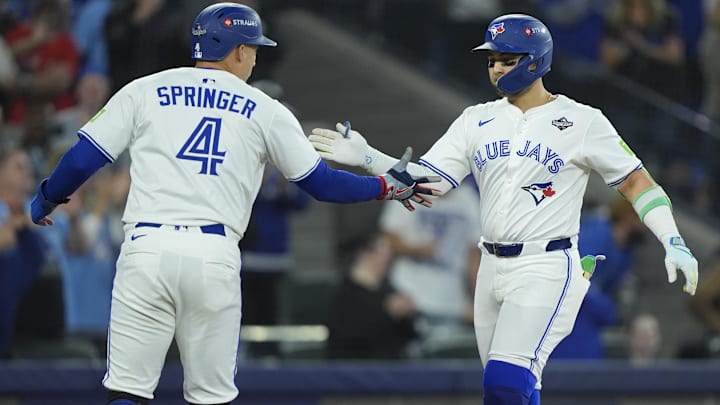 Nov 1, 2025; Toronto, Ontario, CAN; Toronto Blue Jays designated hitter Bo Bichette (11) celebrates with right fielder George Springer (4) after hitting a three run home run against the Los Angeles Dodgers in the third inning during game seven of the 2025 MLB World Series at Rogers Centre. Nov 1, 2025; Toronto, Ontario, CAN; Toronto Blue Jays designated hitter Bo Bichette (11) celebrates with right fielder George Springer (4) after hitting a three run home run against the Los Angeles Dodgers in the third inning during game seven of the 2025 MLB World Series at Rogers Centre.