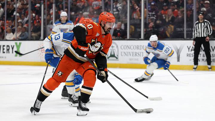 Mar 8, 2026; Anaheim, California, USA;  Anaheim Ducks left wing Chris Kreider (20) skates with the puck past St. Louis Blues right wing Alexey Toropchenko (13) during the second period at Honda Center. Mandatory Credit: Kiyoshi Mio-Imagn Images