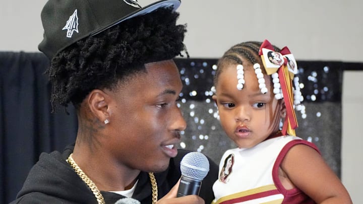 Friends and family celebrate after Booker High defensive end/wide receiver Chauncey Kennon announces he has selected Florida State University to commit to during a party Sunday afternoon, July 6, 2025 at the DeSoto Boys and Girls Club in Bradenton.