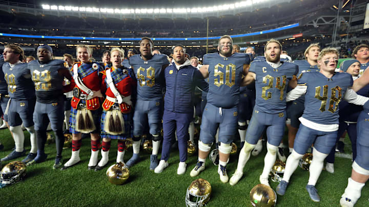 Nov 23, 2024; New York, New York, USA; Notre Dame Fighting Irish head coach Marcus Freeman and his players sing the Notre Dame alma mater after a win against the Army Black Knights at Yankee Stadium. Mandatory Credit: Danny Wild-Imagn Images Nov 23, 2024; New York, New York, USA; Notre Dame Fighting Irish head coach Marcus Freeman and his players sing the Notre Dame alma mater after a win against the Army Black Knights at Yankee Stadium. Mandatory Credit: Danny Wild-Imagn Images