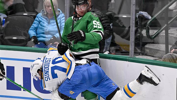 Feb 4, 2026; Dallas, Texas, USA; St. Louis Blues center Oskar Sundqvist (70) checks Dallas Stars defenseman Thomas Harley (55) during the third period at the American Airlines Center. Mandatory Credit: Jerome Miron-Imagn Images