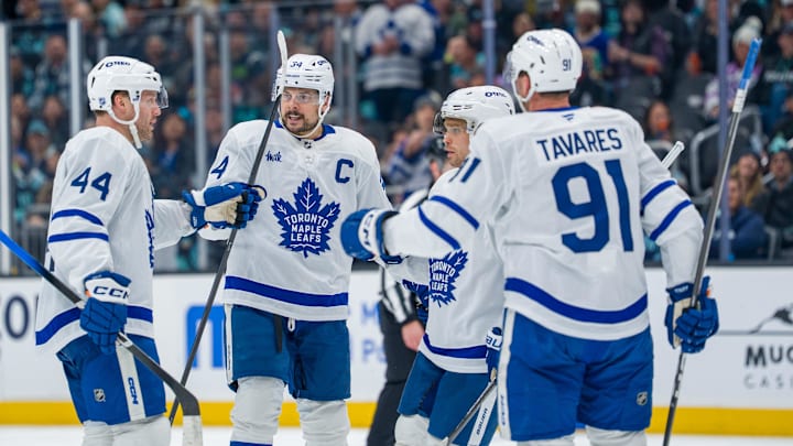 Jan 29, 2026; Seattle, Washington, USA; Toronto Maple Leafs, from left, defenseman Morgan Rielly (44), forward Auston Matthews (34), forward Max Domi (11) and forward John Tavares (91) celebrate a goal during the third period at Climate Pledge Arena. Mandatory Credit: Stephen Brashear-Imagn Images
