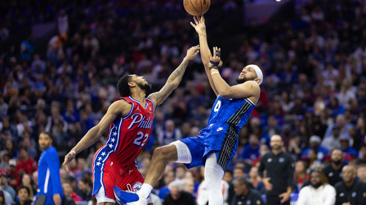 Apr 12, 2024; Philadelphia, Pennsylvania, USA; Orlando Magic guard Jalen Suggs (4) shoots while being fouled by Philadelphia 76ers guard Cameron Payne (22) during the second quarter at Wells Fargo Center. Mandatory Credit: Bill Streicher-USA TODAY Sports
