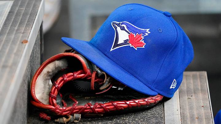 A Toronto Blue Jays hat and glove A Toronto Blue Jays hat and glove
