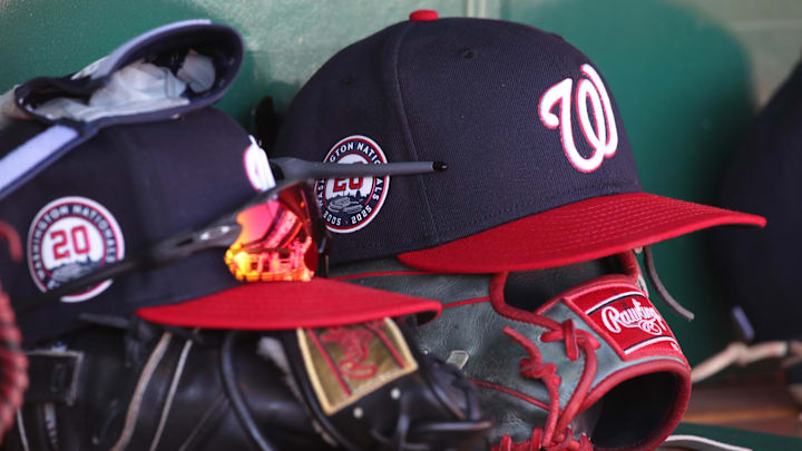 Dark blue Washington Nationals hats on top of black mitts