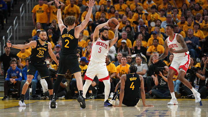 May 2, 2025; San Francisco, California, USA; Houston Rockets guard Fred VanVleet (5) holds onto the ball next to Golden State Warriors guard Stephen Curry (30), guard Brandin Podziemski (2) and guard Moses Moody (4) in the third quarter of game six of the first round for the 2025 NBA Playoffs at Chase Center. Mandatory Credit: Cary Edmondson-Imagn Images