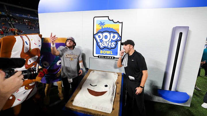 Dec 28, 2024; Orlando, FL, USA; Iowa State Cyclones head coach Matt Campbell and quarterback Rocco Becht (3) celebrate after beating Miami Hurricanes in the Pop Tarts bowl at Camping World Stadium. Mandatory Credit: Nathan Ray Seebeck-Imagn Images Dec 28, 2024; Orlando, FL, USA; Iowa State Cyclones head coach Matt Campbell and quarterback Rocco Becht (3) celebrate after beating Miami Hurricanes in the Pop Tarts bowl at Camping World Stadium. Mandatory Credit: Nathan Ray Seebeck-Imagn Images