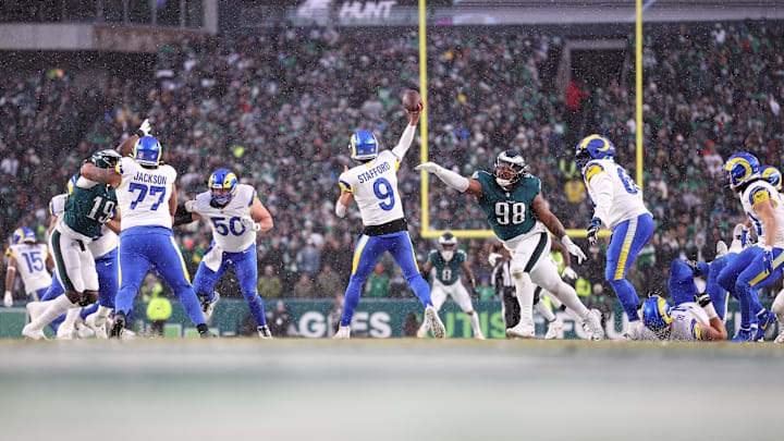 Jan 19, 2025; Philadelphia, Pennsylvania, USA; Los Angeles Rams quarterback Matthew Stafford (9) throws the ball as Philadelphia Eagles defensive tackle Jalen Carter (98) defends in the second quarter in a 2025 NFC divisional round game at Lincoln Financial Field. Mandatory Credit: Bill Streicher-Imagn Images