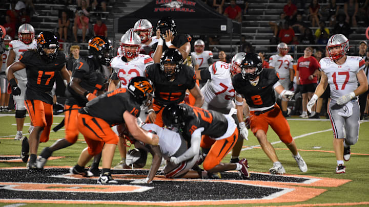 Oviedo's defense stuffs Lake Mary running back O'Shea Faison on Friday night in a preseason Kickoff Classic game. The Lions won 14-9.