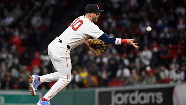 Apr 7, 2026; Boston, Massachusetts, USA; Boston Red Sox shortstop Trevor Story (10) tosses the ball to first base during the fourth inning against the Milwaukee Brewers at Fenway Park. Mandatory Credit: Eric Canha-Imagn Images