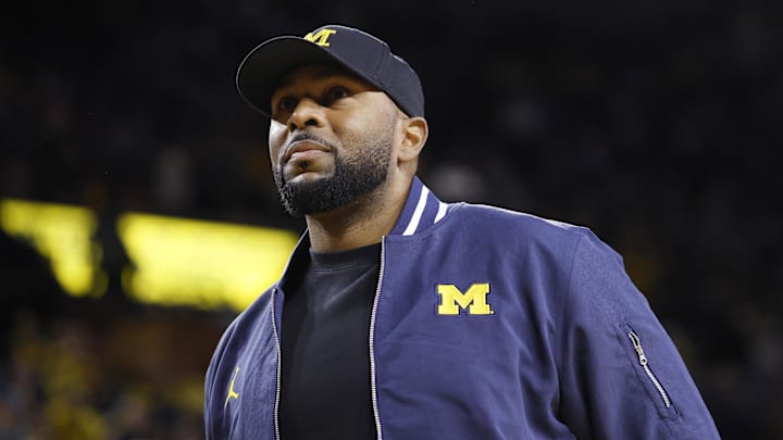 Michigan Wolverines head football coach Sherrone Moore fires up the crowd in overtime of the basketball game against the Northwestern Wildcats at Crisler Center.