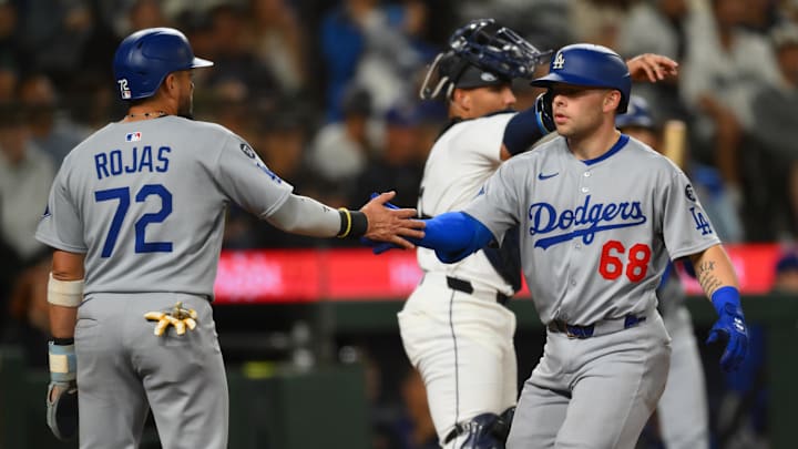 Los Angeles Dodgers second baseman Miguel Rojas (72) and catcher Dalton Rushing (68) celebrate a home run hit by Rushing during the fifth inning against the Seattle Mariners at T-Mobile Park on Sept. 27.