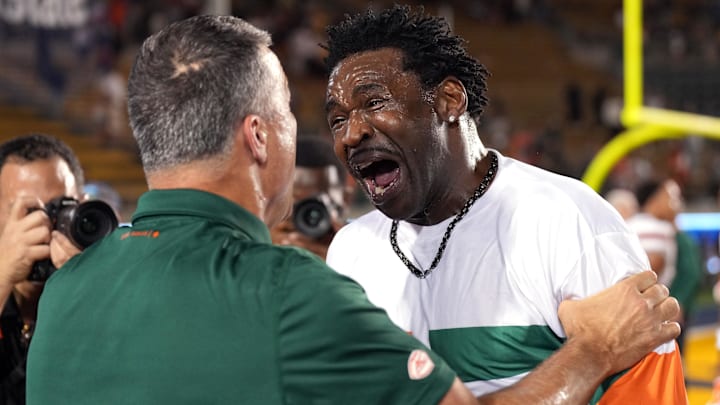Oct 5, 2024; Berkeley, California, USA; Miami Hurricanes former player Michael Irvin (right) celebrates with head coach Mario Cristobal (left) after the game against the California Golden Bears at California Memorial Stadium. Mandatory Credit: Darren Yamashita-Imagn Images