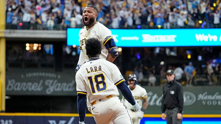 Oct 4, 2026; Milwaukee, Wisconsin, USA;  Milwaukee Brewers outfielder Jackson Chourio (11) celebrates with Milwaukee Brewers outfielder Luis Lara (18) after hitting the game-winning play against the San Diego Padres in game two of the NLDS for the 2026 MLB Playoffs at American Family Field.  Mandatory Credit: Michael McLoone-Imagn Images