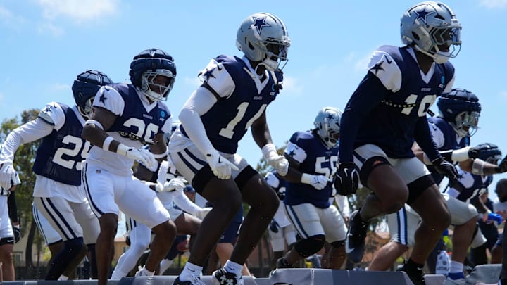 Dallas Cowboys defensive players run drills at training camp at the River Ridge Fields.