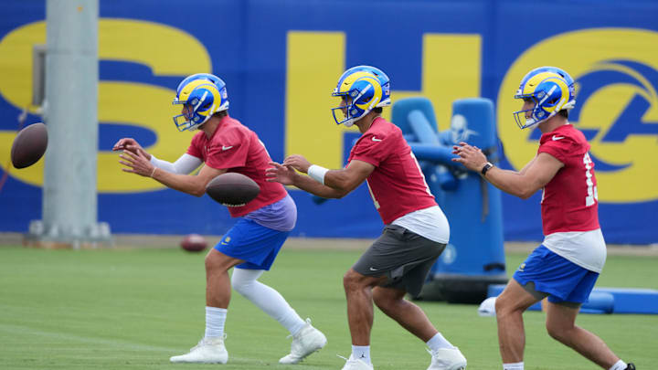 Jun 3, 2025; Woodland Hills, CA, USA; Los Angeles Rams quarterbacks Matthew Stafford (left), Jimmy Garoppolo (center) and Stetson Bennett take the snap during organized team activities at Rams Practice Facility. Mandatory Credit: Kirby Lee-Imagn Images