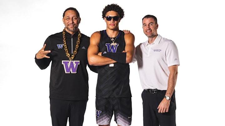 Jasir Rencher shares a moment with UW coaches Tony Bland and Danny Sprinkle.