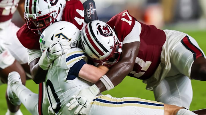 Sep 21, 2024; Columbia, South Carolina, USA; South Carolina Gamecocks linebacker Demetrius Knight Jr. (17) commits a late-hit penalty on Akron Zips quarterback Ben Finley (10) in the second half at Williams-Brice Stadium. Mandatory Credit: Jeff Blake-Imagn Images Sep 21, 2024; Columbia, South Carolina, USA; South Carolina Gamecocks linebacker Demetrius Knight Jr. (17) commits a late-hit penalty on Akron Zips quarterback Ben Finley (10) in the second half at Williams-Brice Stadium. Mandatory Credit: Jeff Blake-Imagn Images