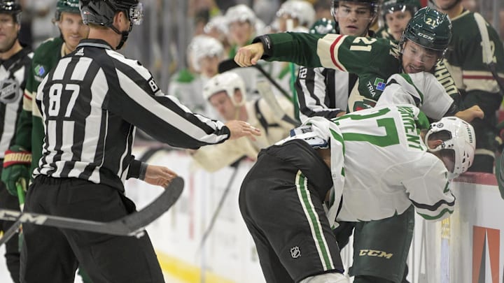 Oct 7, 2023; Saint Paul, Minnesota, USA; Minnesota Wild forward Brandon Duhaime (21) and Dallas Stars forward Mason Marchment (27) fight during the third period at Xcel Energy Center. Mandatory Credit: Nick Wosika-Imagn Images


