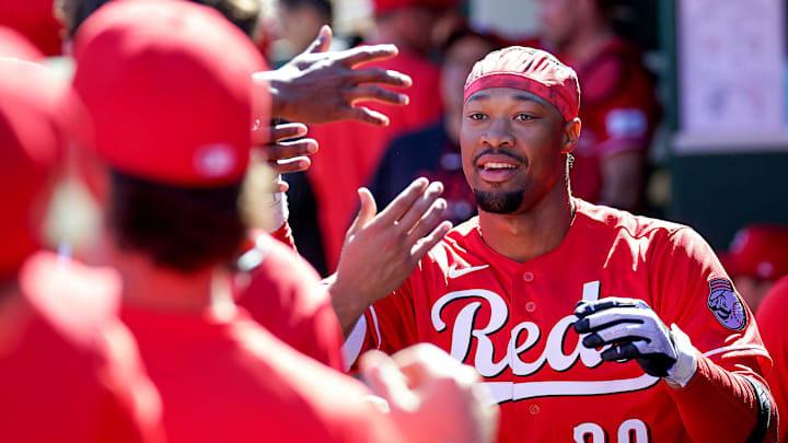Cincinnati Reds left fielder Will Benson (30) is embraced by teammates in the dugout after hitting a homer in the third inning of a Cactus League game between the Cincinnati Reds and Cleveland Guardians, Saturday, Feb. 21, 2026, at Goodyear Ballpark in Goodyear, Ariz.