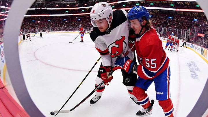 Sep 26, 2022; Montreal, Quebec, CAN; Montreal Canadiens forward Michael Pezzetta (55) and New Jersey Devils defenseman Reilly Walsh (8) battle for the puck during the second period at the Bell Centre. Mandatory Credit: Eric Bolte-USA TODAY Sports