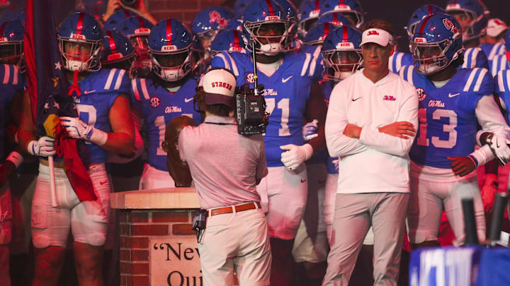 Nov 15, 2025; Oxford, Mississippi, USA; Mississippi Rebels head coach Lane Kiffin stands with his players before a game against the Florida Gators at Vaught-Hemingway Stadium. Mandatory Credit: Petre Thomas-Imagn Images