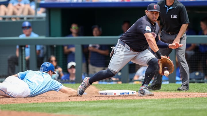 Jun 30, 2024; Kansas City, Missouri, USA; Cleveland Guardians first base Josh Naylor (22) reaches for a throw as Kansas City Royals second base Nick Loftin (12) dives back to first base during the sixth inning at Kauffman Stadium. Mandatory Credit: William Purnell-USA TODAY Sports Jun 30, 2024; Kansas City, Missouri, USA; Cleveland Guardians first base Josh Naylor (22) reaches for a throw as Kansas City Royals second base Nick Loftin (12) dives back to first base during the sixth inning at Kauffman Stadium. Mandatory Credit: William Purnell-USA TODAY Sports