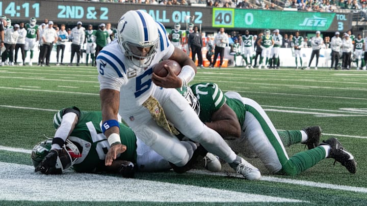 Nov 17, 2024; East Rutherford, New Jersey, USA; Indianapolis Colts quarterback Anthony Richardson (5) scores a touchdown over New York Jets safety Jalen Mills (35) and defensive end Micheal Clemons (72) in the first half at MetLife Stadium. Mandatory Credit: Robert Deutsch-Imagn Images