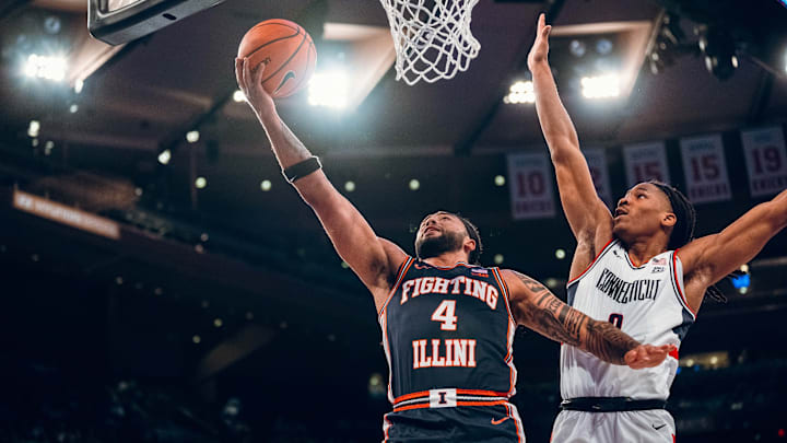 Illinois guard Kylan Boswell (4) finish at the rim against a UConn defender in the Illini's 74-61 loss to the Huskies last week at Madison Square Garden in New York City. Illinois guard Kylan Boswell (4) finish at the rim against a UConn defender in the Illini's 74-61 loss to the Huskies last week at Madison Square Garden in New York City.