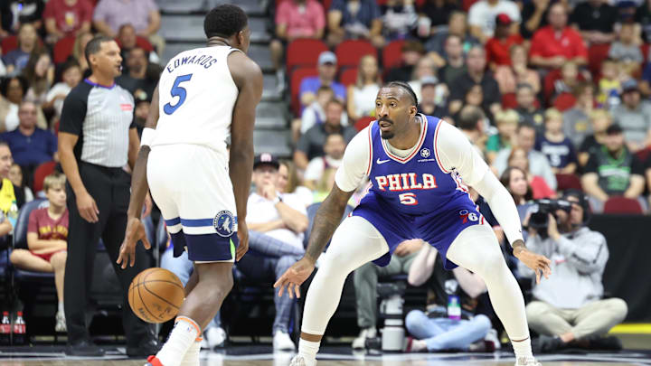 Oct 11, 2024; Des Moines, Iowa, USA;  Philadelphia 76ers center Andre Drummond (5) defends Minnesota Timberwolves guard Anthony Edwards (5) at Wells Fargo Arena. Mandatory Credit: Reese Strickland-Imagn Images