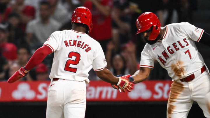 Jun 29, 2024; Anaheim, California, USA; Los Angeles Angels third baseman Luis Rengifo (2) fives outfielder Jo Adell (7) after scoring against the Detroit Tigers during the seventh inning at Angel Stadium. Mandatory Credit: Jonathan Hui-USA TODAY Sports