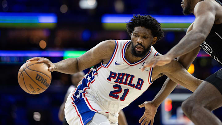 Feb 22, 2025; Philadelphia, Pennsylvania, USA; Philadelphia 76ers center Joel Embiid (21) controls the ball against Brooklyn Nets center Day'Ron Sharpe (20) during the third quarter at Wells Fargo Center. Mandatory Credit: Bill Streicher-Imagn Images