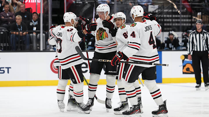 Oct 8, 2024; Salt Lake City, Utah, USA; The Chicago Blackhawks celebrate a goal by Chicago Blackhawks defenseman Alex Vlasic (center) against the Utah Hockey Club during the third period at Delta Center. Mandatory Credit: Rob Gray-Imagn Images