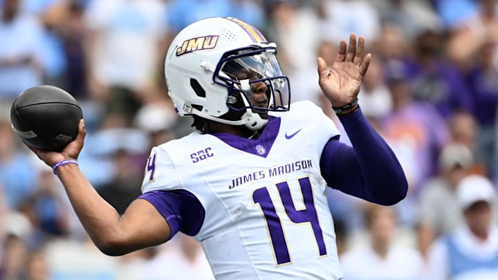 James Madison Dukes quarterback Alonza Barnett III (14) looks to pass in the first quarter at Kenan Memorial Stadium. He led the Dukes to a 70-50 win over North Carolina and school records for touchdowns (7) and offensive yards (487). He played his high school football at Grimsley High (North Carolina).