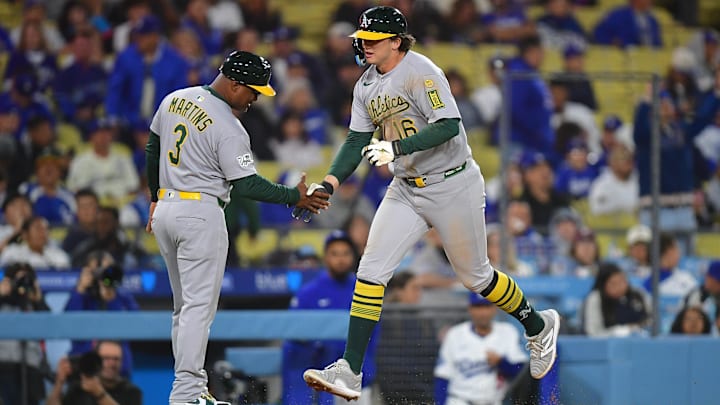 May 13, 2025; Los Angeles, California, USA; Athletics first baseman Nick Kurtz (16) is greeted by third base coach Eric Martins (3) after hitting a solo home run against the Los Angeles Dodgers during the eighth inning at Dodger Stadium. Mandatory Credit: Gary A. Vasquez-Imagn Images