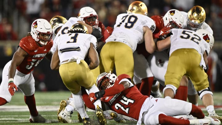 Oct 7, 2023; Louisville, Kentucky, USA; Louisville Cardinals linebacker Jaylin Alderman (24) tackles Notre Dame Fighting Irish running back Gi'Bran Payne (3) during the second half at L&N Federal Credit Union Stadium. Louisville defeated Notre Dame 33-20. Mandatory Credit: Jamie Rhodes-USA TODAY Sports