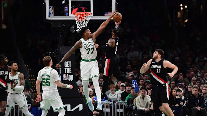 Jan 26, 2026; Boston, Massachusetts, USA; Boston Celtics forward Amari Williams (77) blocks the shot of Portland Trail Blazers guard Caleb Love (2) during the second half at TD Garden. Mandatory Credit: Bob DeChiara-Imagn Images