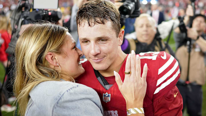 San Francisco 49ers quarterback Brock Purdy (13) kisses his then fiancee Jenna Brandt after winning the NFC Championship football game against the Detroit Lions.