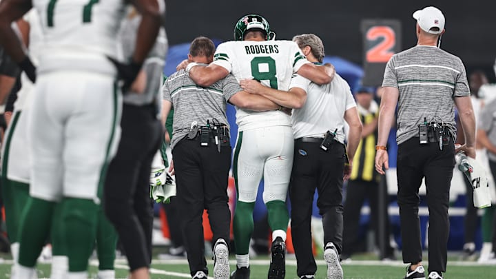 Aaron Rodgers is helped off the field after suffering an injury against the Buffalo Bills.