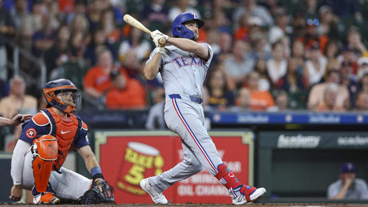 Jul 14, 2024; Houston, Texas, USA; Texas Rangers third baseman Josh Smith (8) hits a two-run home run during the first inning against the Houston Astros at Minute Maid Park. Mandatory Credit: Troy Taormina-USA TODAY Sports