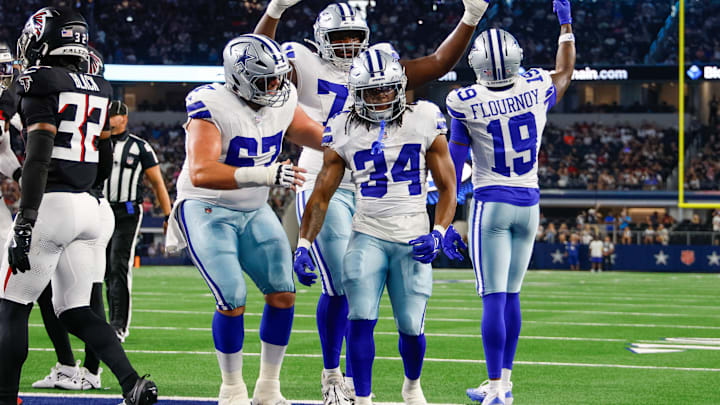 Teammates celebrate with Dallas Cowboys running back Jaydon Blue after he scores a touchdown against the Atlanta Falcons. Teammates celebrate with Dallas Cowboys running back Jaydon Blue after he scores a touchdown against the Atlanta Falcons.