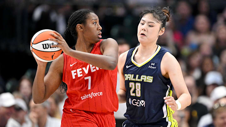 Jun 27, 2025; Dallas, Texas, USA; Indiana Fever forward Aliyah Boston (7) and Dallas Wings center Li Yueru (28) in action during the game between the Dallas Wings and the Indiana Fever at the American Airlines Center. Mandatory Credit: Jerome Miron-Imagn Images