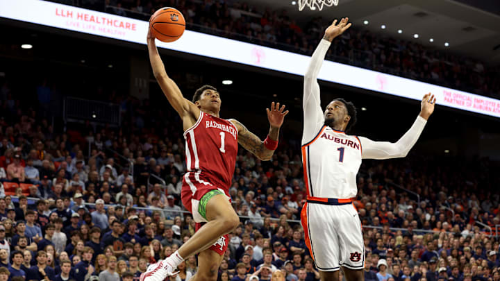 Jan 10, 2026; Auburn, Alabama, USA; Arkansas Razorbacks guard Meleek Thomas (1) goes up for a shot as Auburn Tigers guard Kevin Overton (1) defends during the first half at Neville Arena. Mandatory Credit: John Reed-Imagn Images Jan 10, 2026; Auburn, Alabama, USA; Arkansas Razorbacks guard Meleek Thomas (1) goes up for a shot as Auburn Tigers guard Kevin Overton (1) defends during the first half at Neville Arena. Mandatory Credit: John Reed-Imagn Images
