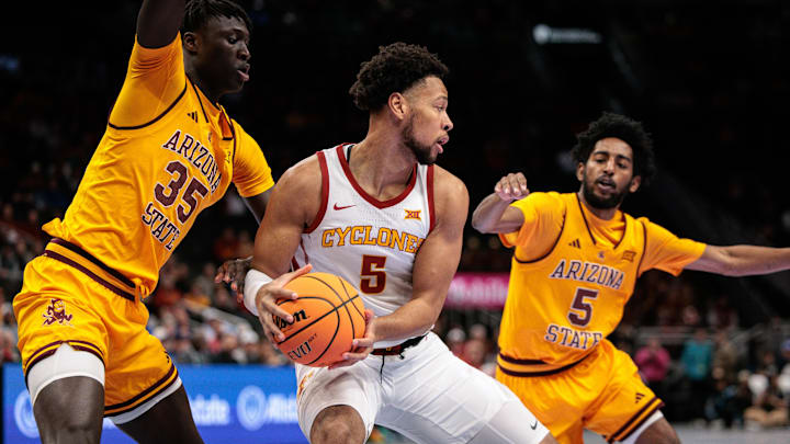Mar 11, 2026; Kansas City, MO, USA; Iowa State Cyclones forward Joshua Jefferson (5) protects the ball from Arizona State Sun Devils center Massamba Diop (35) during the first half at T-Mobile Center. Mandatory Credit: William Purnell-Imagn Images